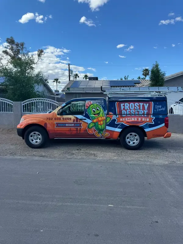 A Frosty Desert Heating & Air service truck with its cactus mascot wrap parked at a Las Vegas home